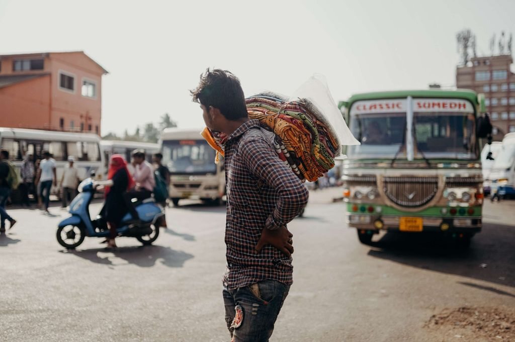 man in a plaid shirt walking on the street-mgnrega