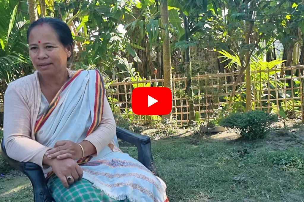 a woman sitting on a chair--pig farm in assam