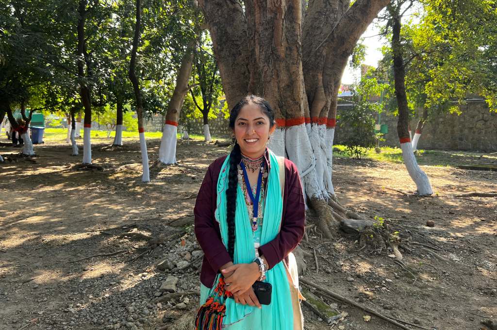 a woman standing in front of a banyan tree--tribal women