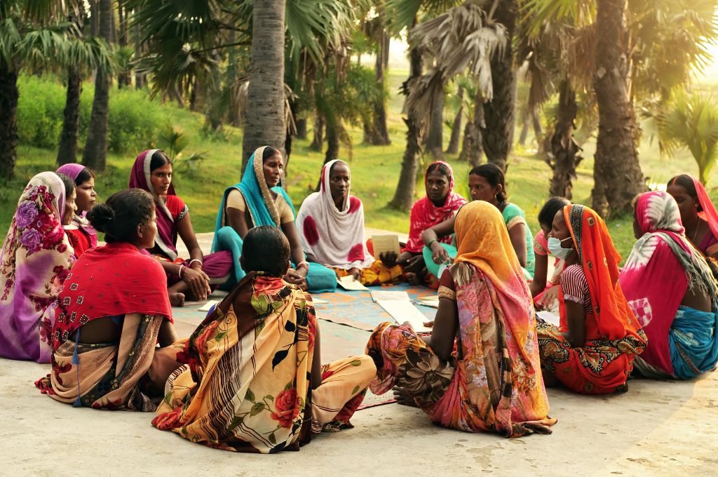 women sitting in a circle in sarees_gender roles