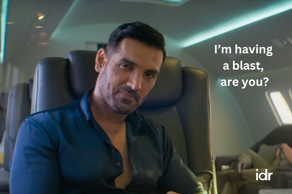 john abraham smirking in an airplane and saying, "I'm having a blast, are you?"--nonprofit humour