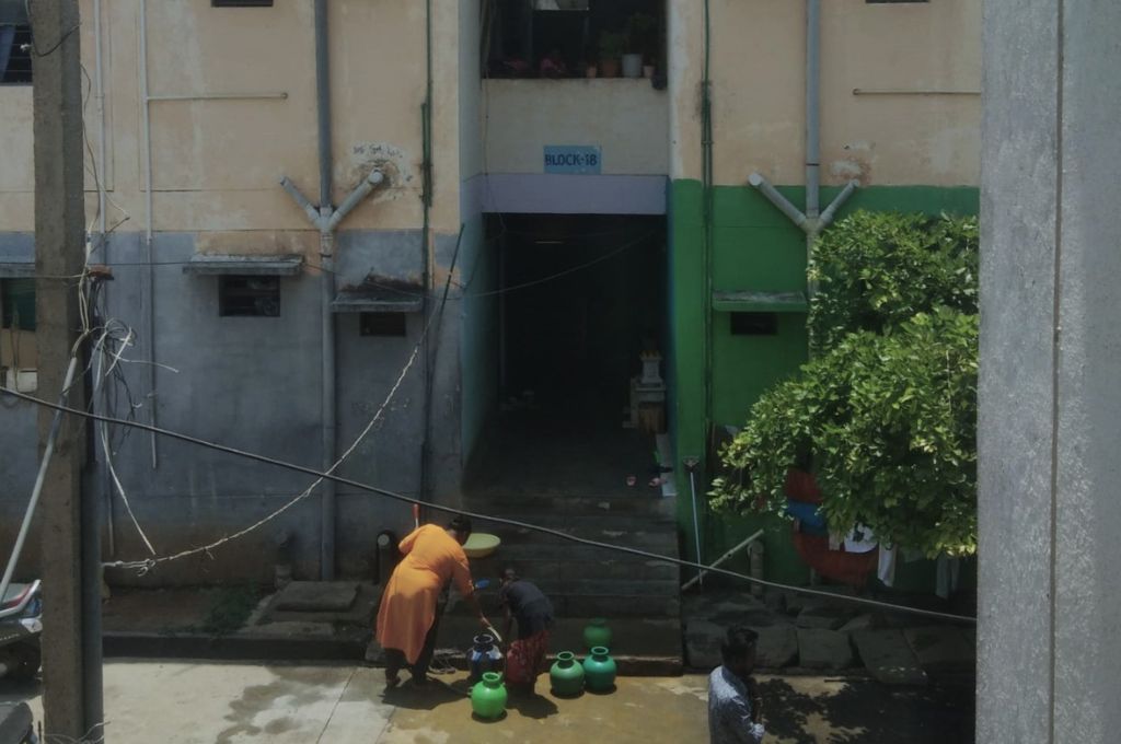 a woman and a child with several pots of water--affordable housing