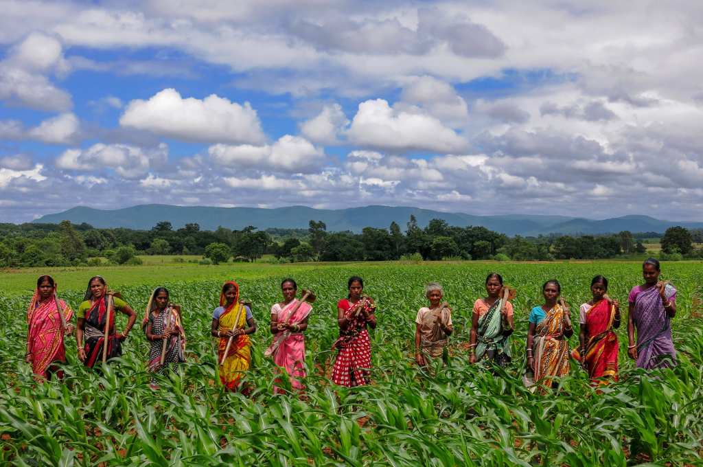 a group of women standing in a field--community water conservation