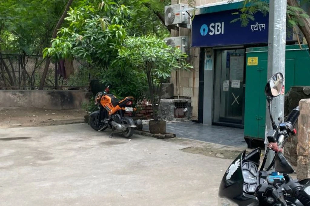Two bikes standing in front of an SBI ATM_child sexual abuse