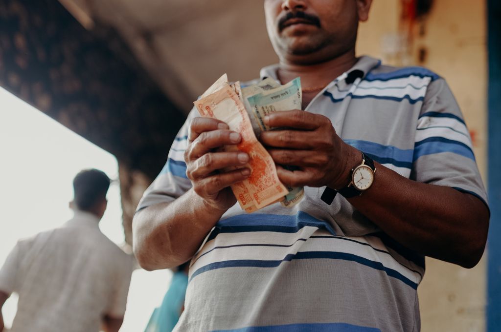 man counting money_microfinance