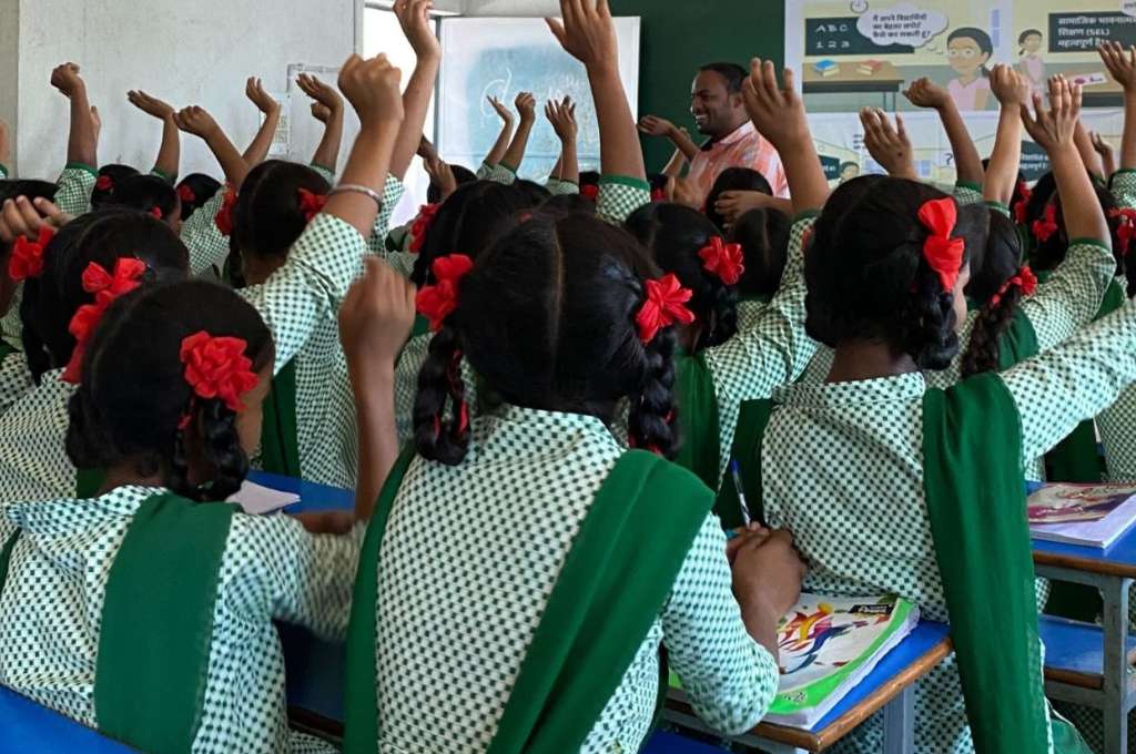 a class of girls with their hands raised--participatory research