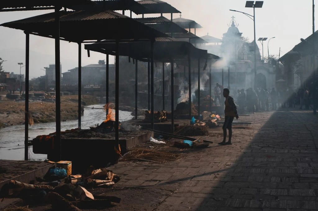 a man standing at a cremation ground