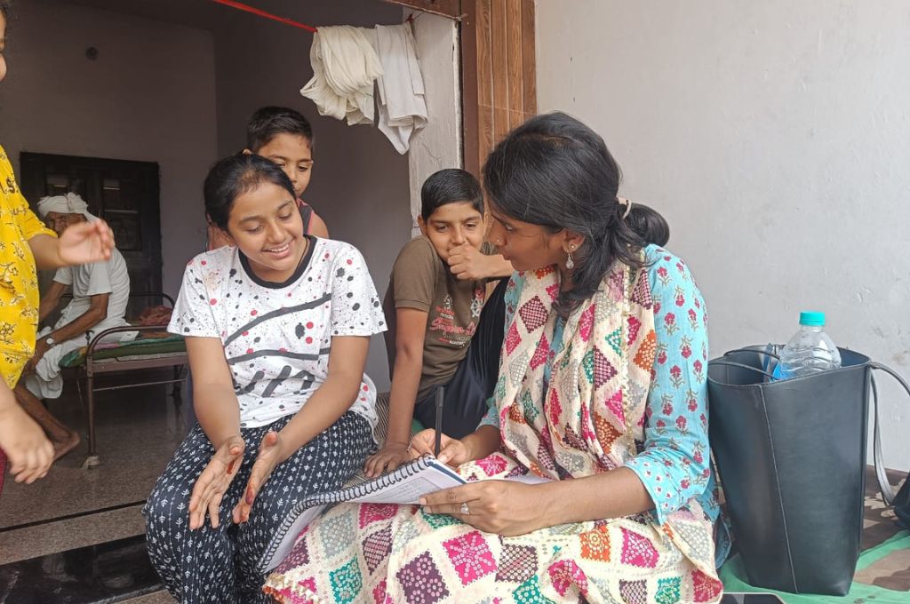 A woman taking a survey of a girl child