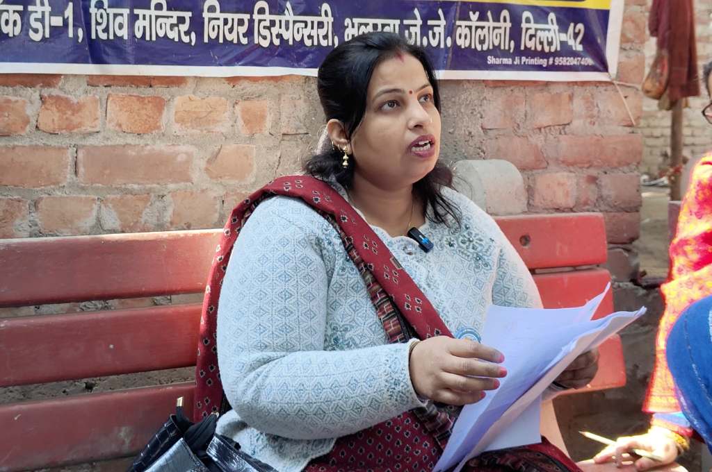 Rama holding some papers is sitting on a bench talking to someone--household air pollution