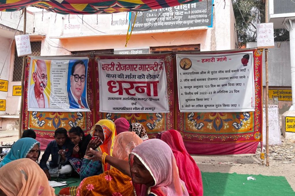 women sitting for a protest regarding mgnrega  