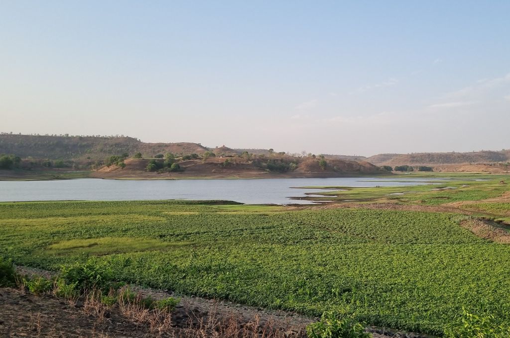 a water body with low hills in the background--moong cultivation benefits