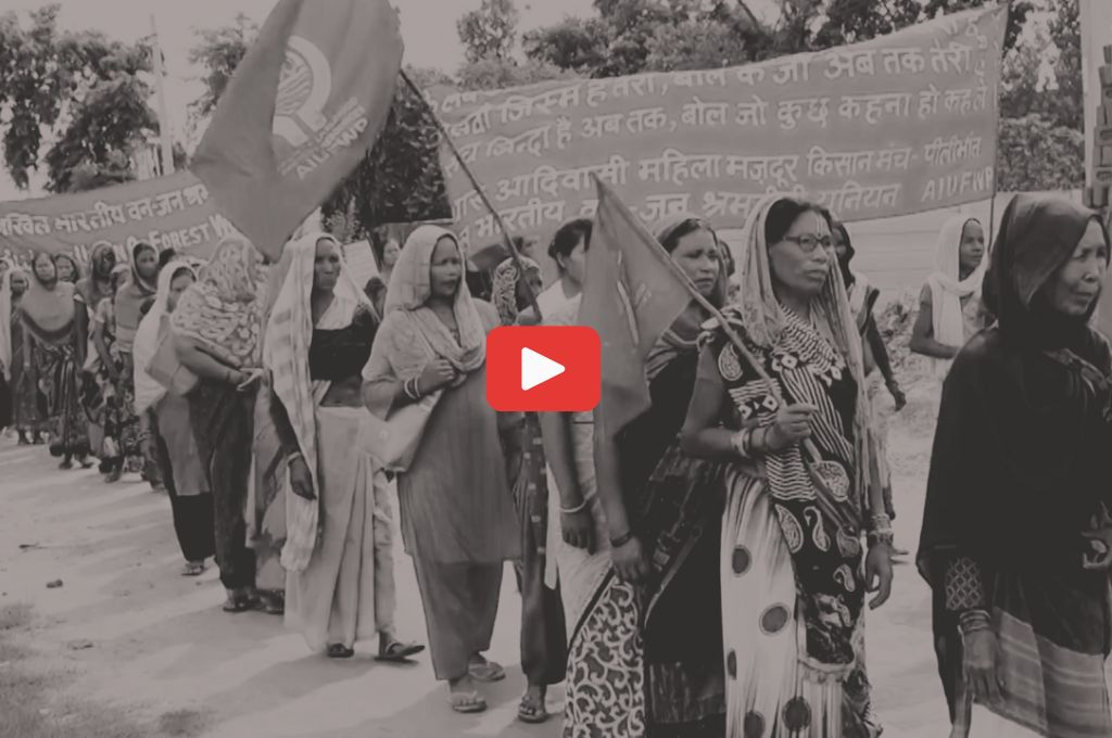 A group of Tharu women holding placards and flags-forest