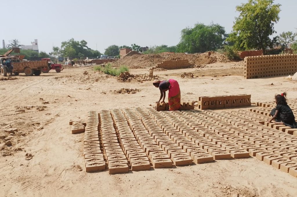 A woman arranging bricks_brick kiln