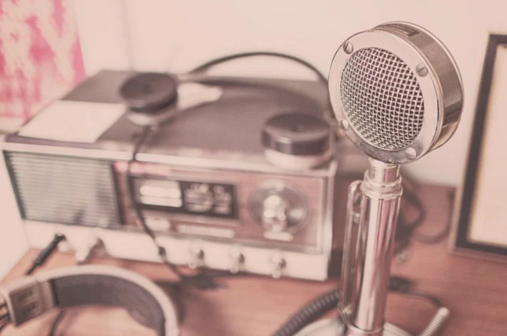 a tinted image of a microphone with a radio in the background--communications