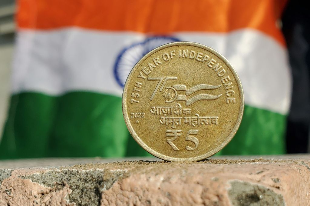 A coin with the flag of India in the background_budget 2024