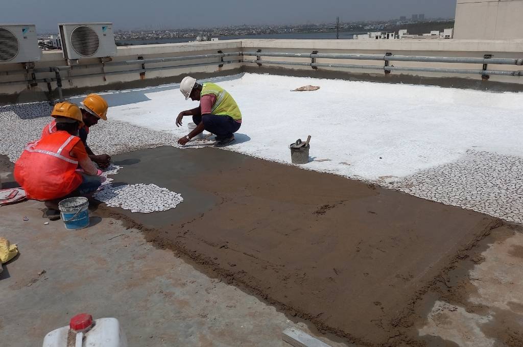 Workers installing China mosaic tiles to keep roofs cool_climate action plans