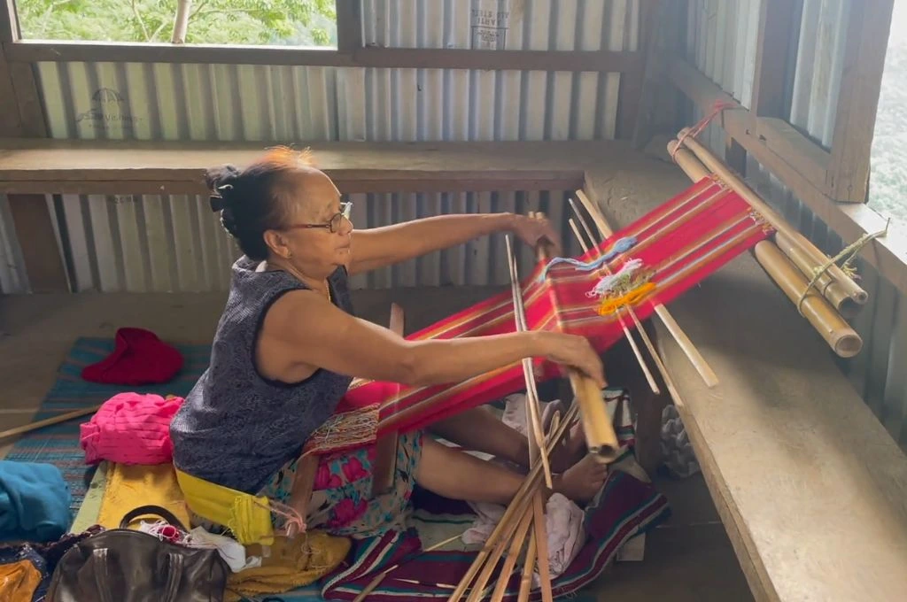 A Chin refugee weaving in a camp