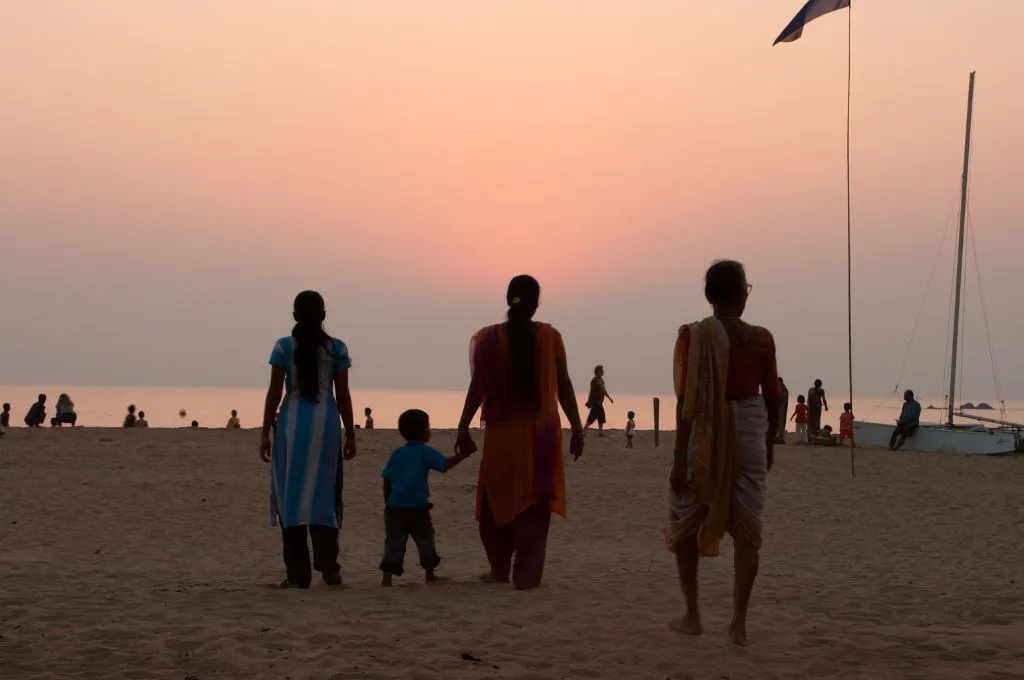 an indian family walking on the beach--family-centred care