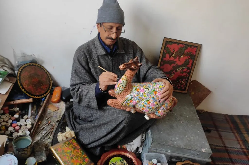 a paper mache artist in Kashmir making a deer in his workshop--paper mache