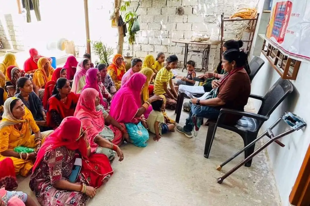 disability rights activist pappu kanwar speaking with a group of women in barmer, rajasthan--disability rights