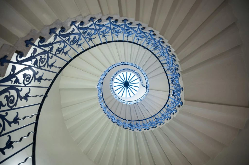 A spiral staircase with blue railings