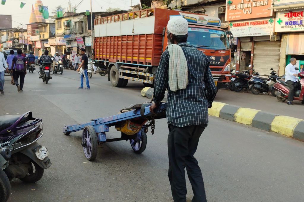 Man pulling a wooden handcart_workers rights