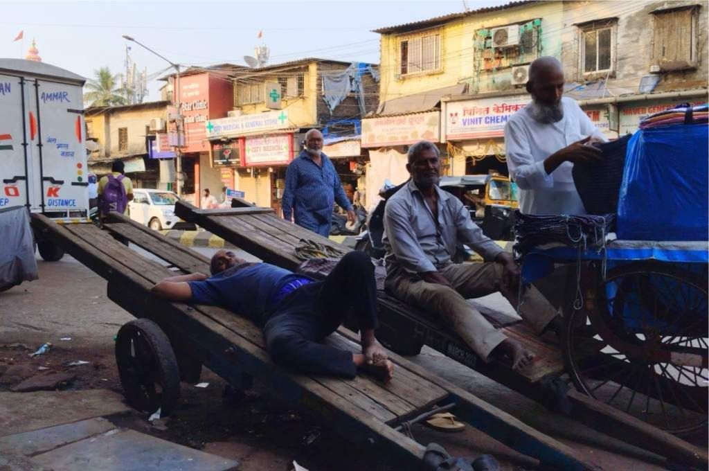 Labours sleeping on handcarts at the side of a road_workers rights