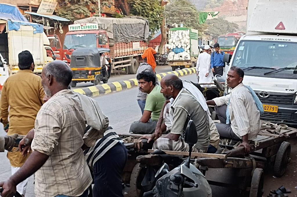 Workers sitting on handcart used to carry luggae_workers rights