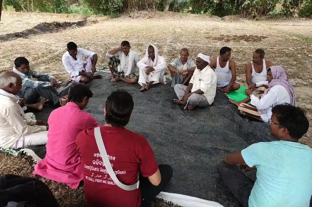 A group of people from rural India sitting on the floor in a circle_grassroots organisations