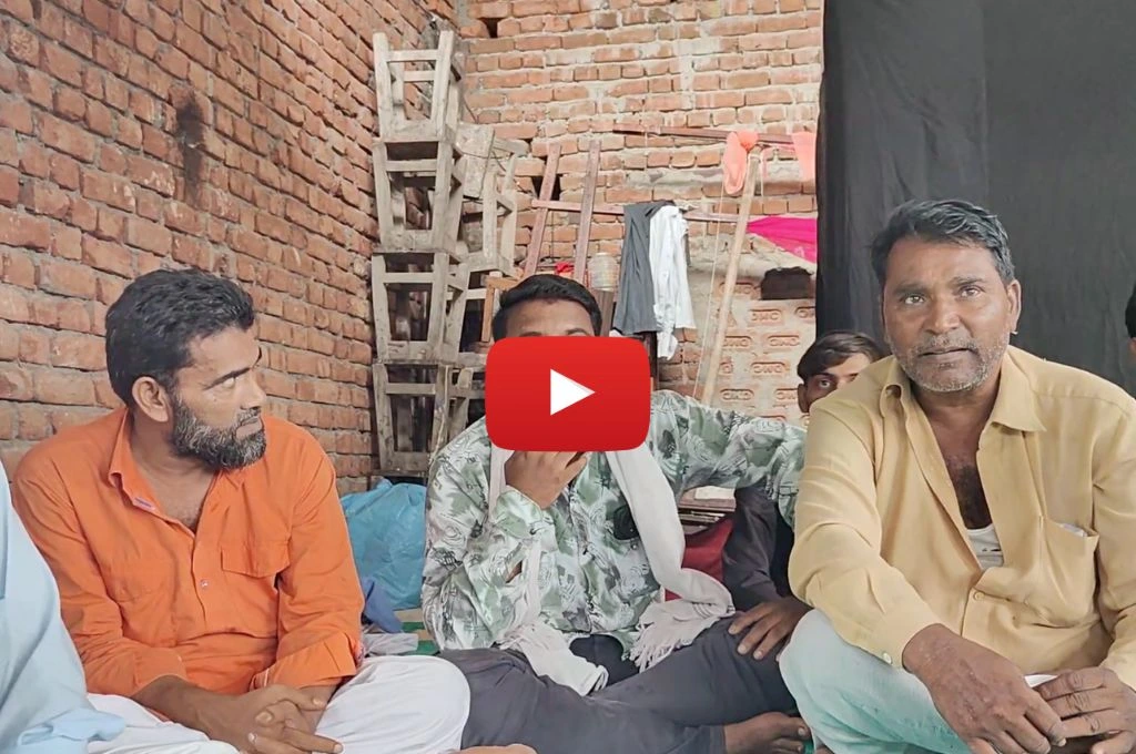 Three men from denotified tribe sitting inside a brick house