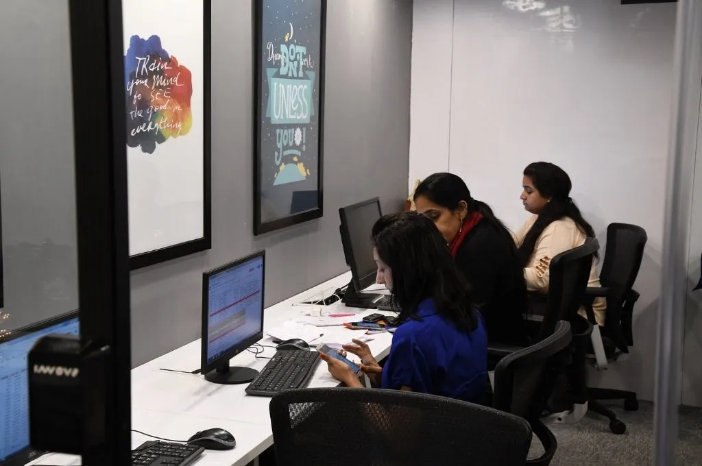 three women working in a co-working space in Delhi, India--AI for nonprofits