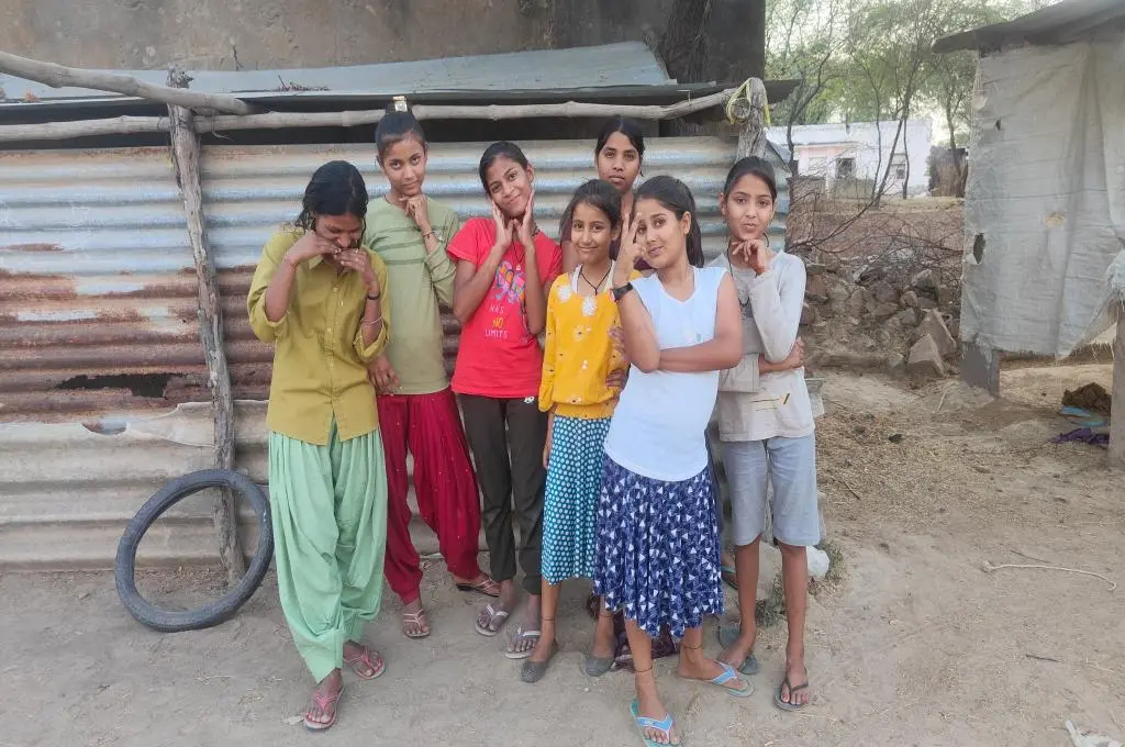 The image features a group of young children smiling and posing for a photo._children and climate