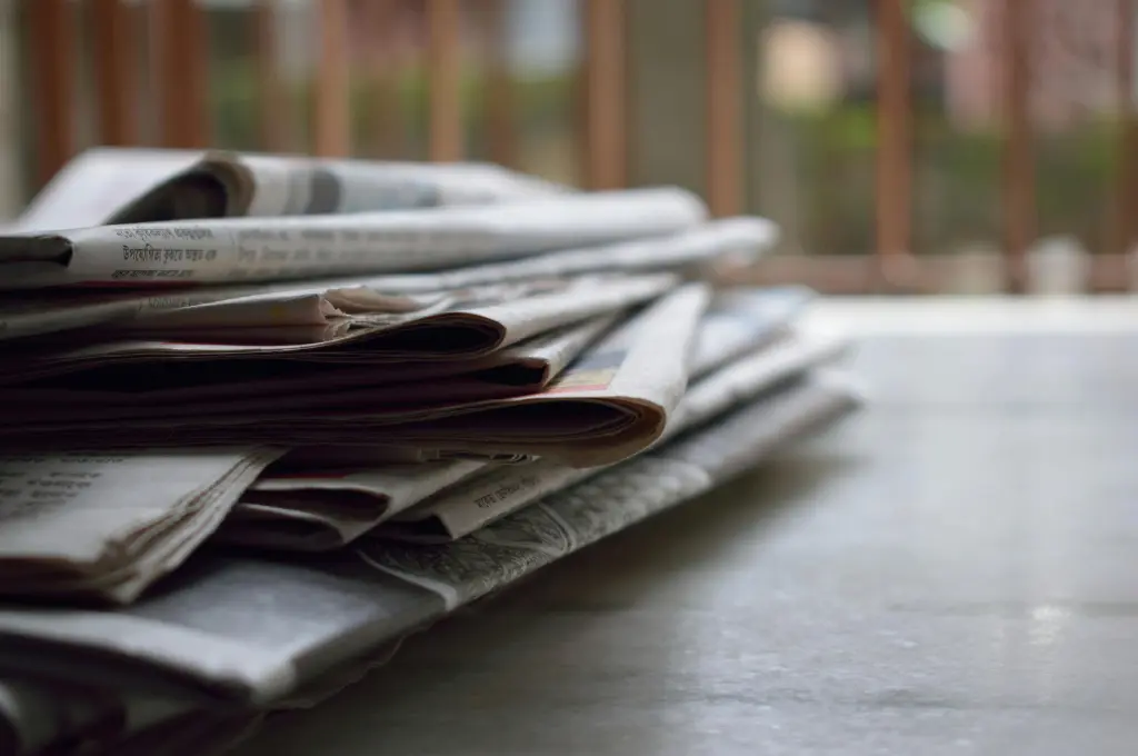 Stack of folded daily newspapers_disability news