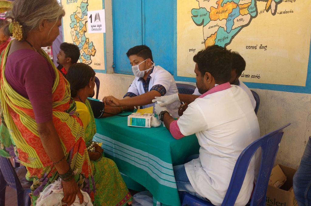 a doctor checking a woman's pulse_anaemia in India