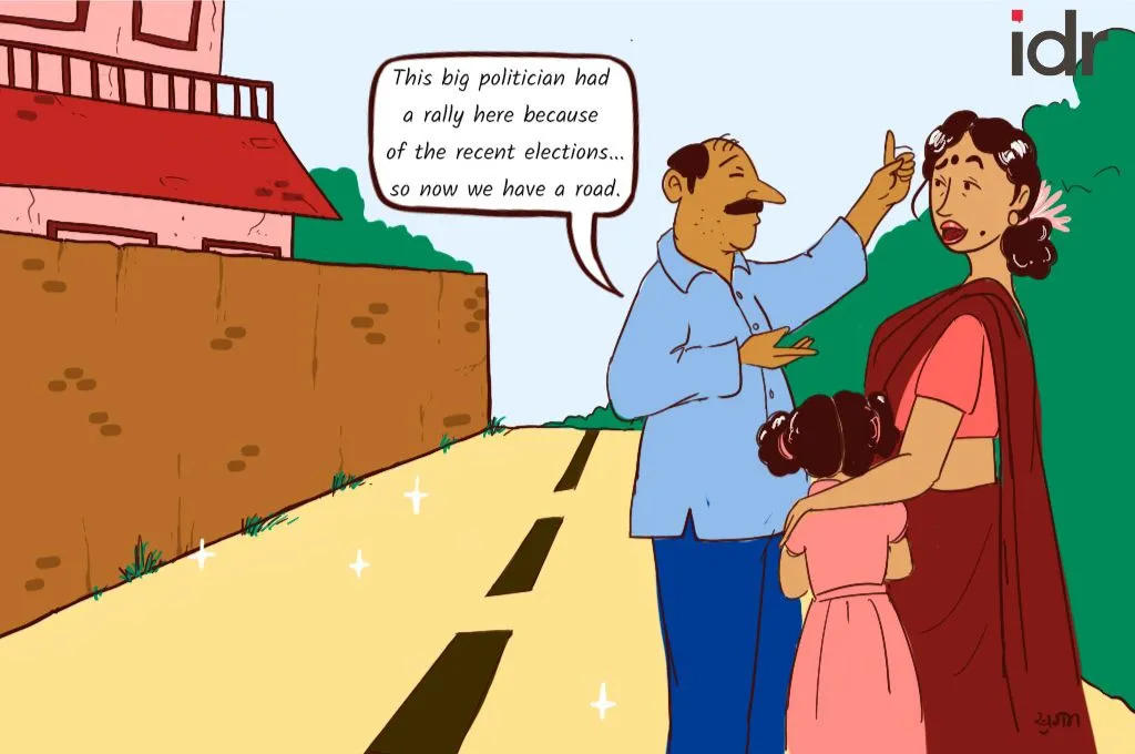 Family stands on newly built road, man explains to his wife and daughter that the road was built because a politician held a rally there ahead of the recent elections_nonprofit humour
