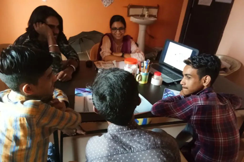 Youth group in discussion around table_community for mental health