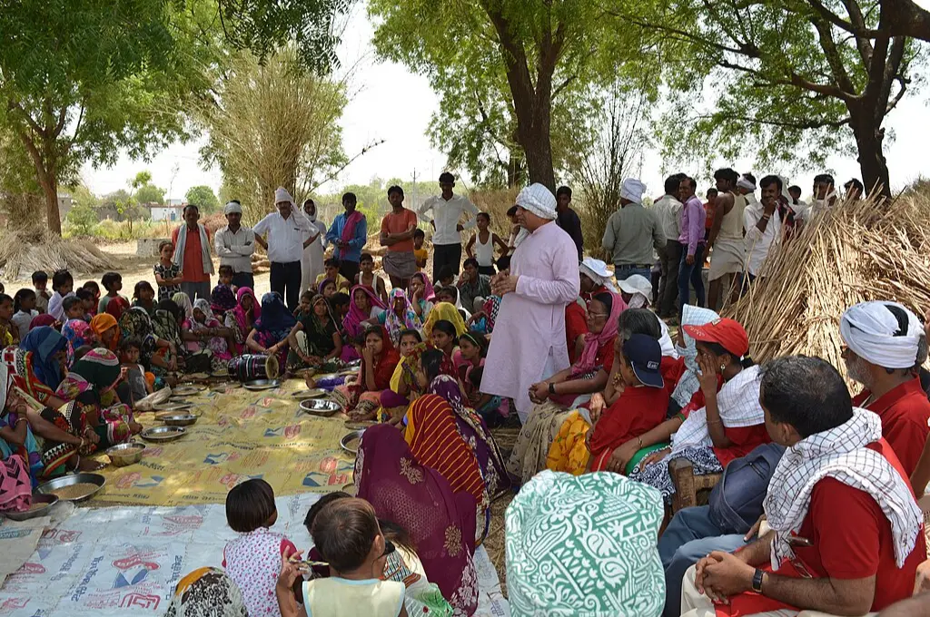 Village community gathers under tree shade_village courts