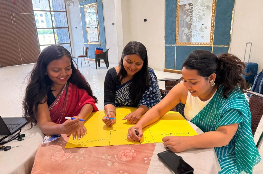 A group of women at a workplace sitting on a table and discussing_gender and inequality