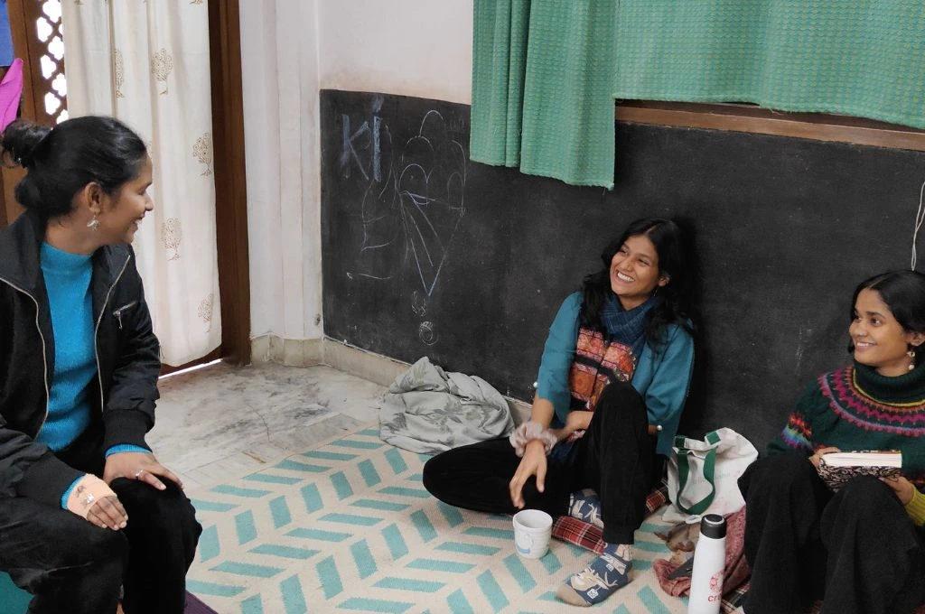 three women co-founders of co-found Aagaaz Theatre Trust sitting on the floor and chatting_community leadership