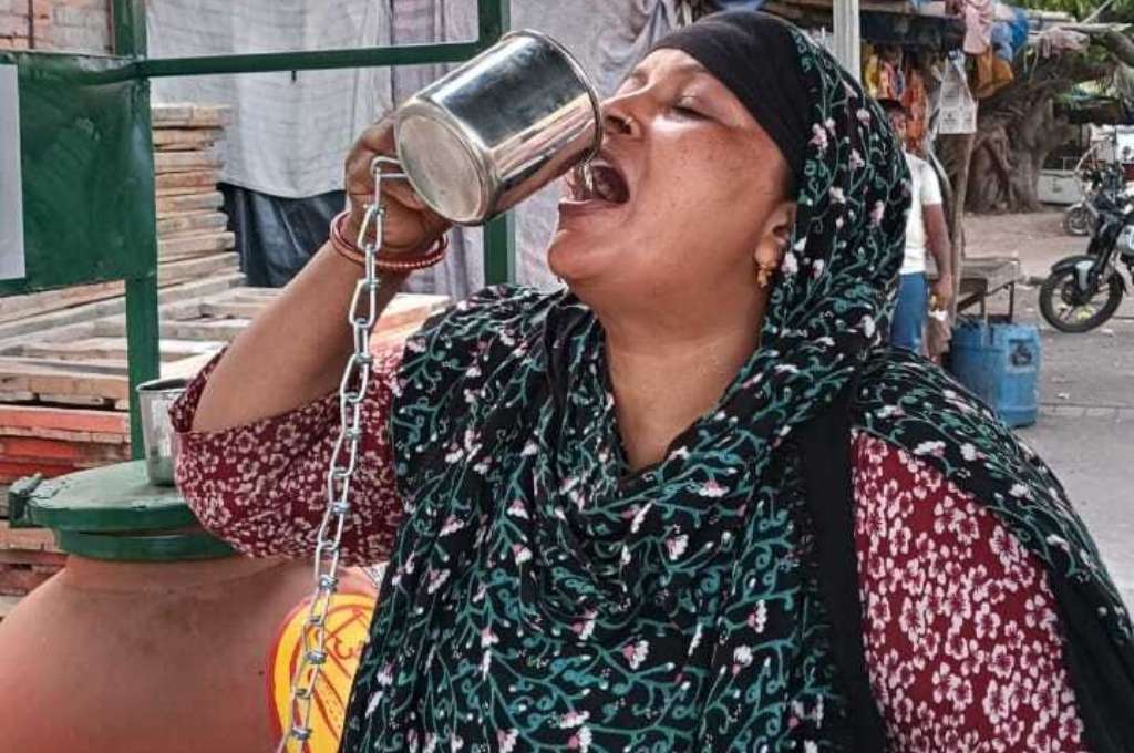 a woman drinking from an earthen matka-water atms