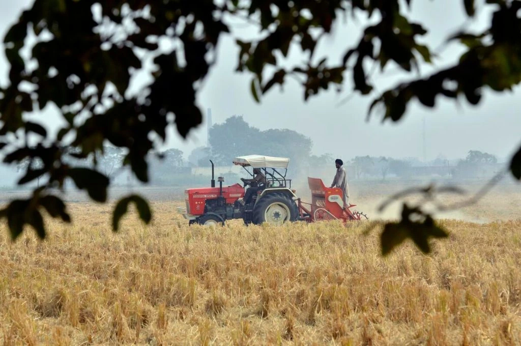 A farmer operating a tractor in a field in India_climate change in India