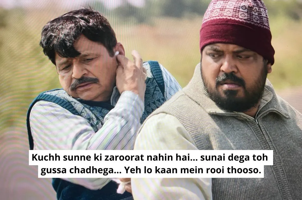 The image features the sarpanch's husband, who is the village pradhan, and the village's deputy pradhan sitting on a motorcycle. The pradhan is holding pieces of cotton in his hand and says, "There is no need to listen to anything. If we listen to what is being said, it will make us angry. Here, stuff this cotton in your ears"._Nonprofit humour