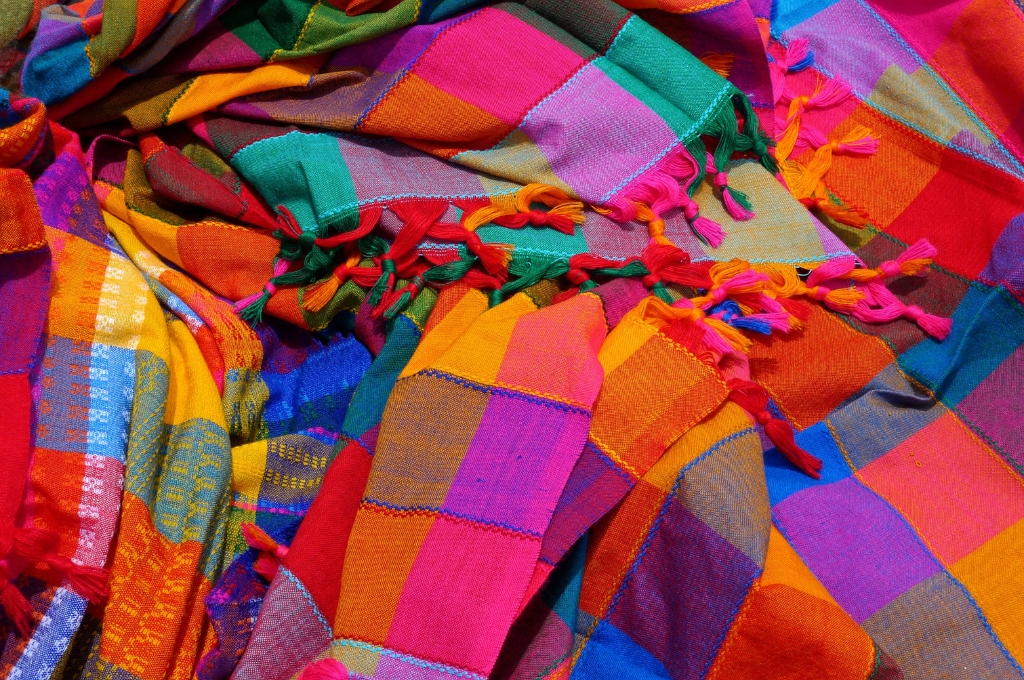 Colourful shawls lying on top of each other--funding