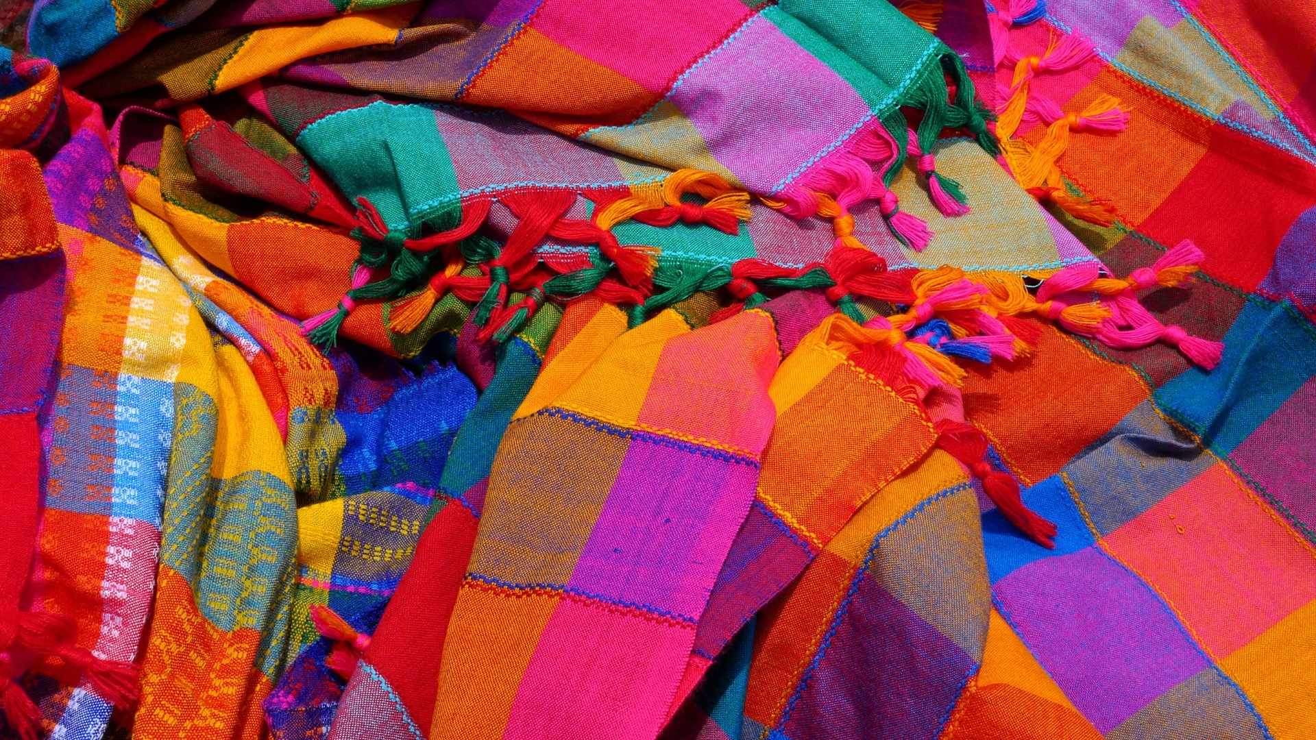 Colourful shawls lying on top of each other--funding