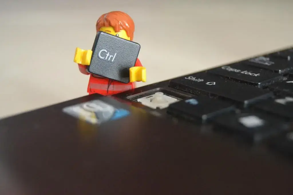 A hi-res image of a computer laptop and a Lego miniature figure holding the CTRL tab-technology for nonprofits.