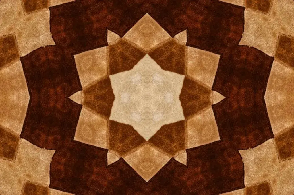 A textile motif in shades of brown and that looks like a kaleidoscopic image-scale
