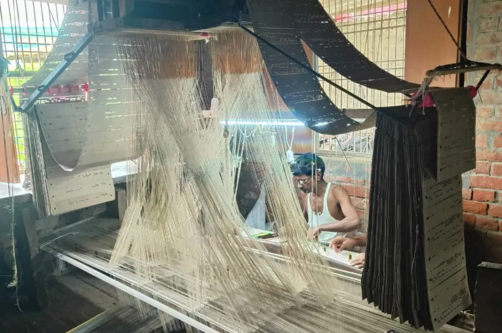 a Banarasi saree weaver operating a loom--Banarasi sarees