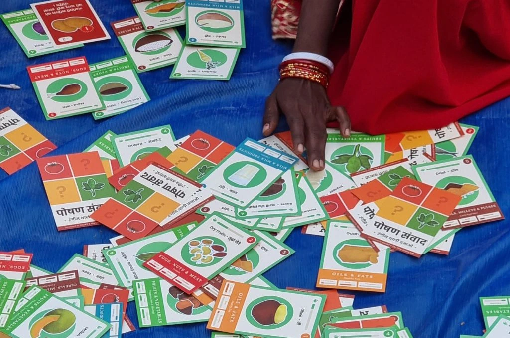 A woman playing cards social impact games