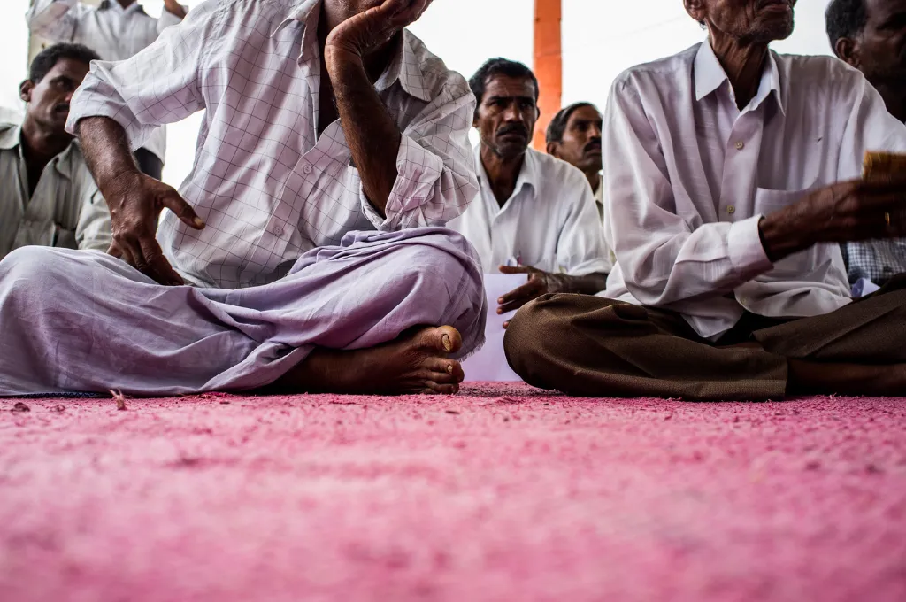 a group of people sitting on a carpeted floor--participant data